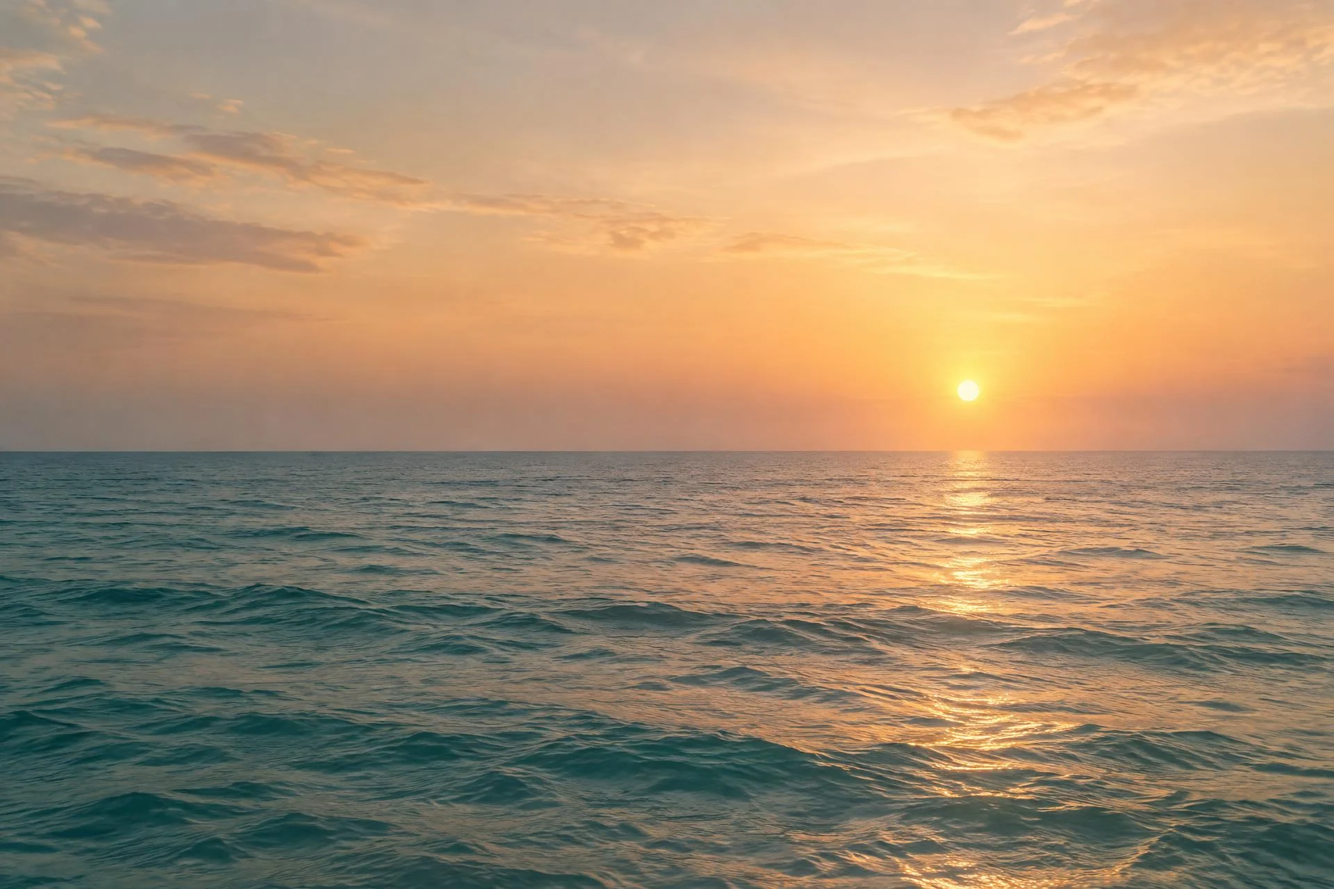 Sun rising over a calm ocean